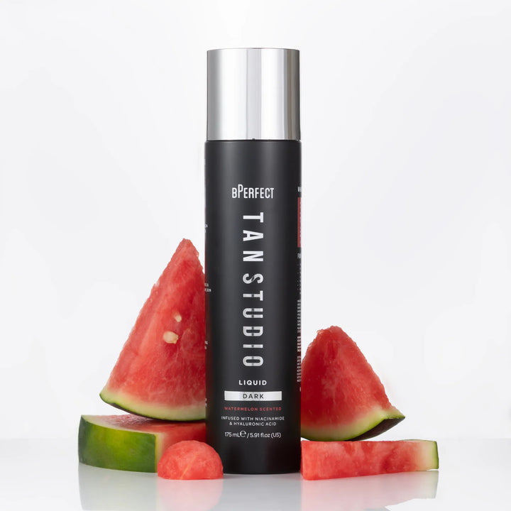 Tan Studio tanning liquid bottle with watermelon slices on a white background