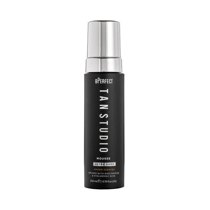 Black bottle of BPerfect Tan Studio Mousse with silver cap on a white background