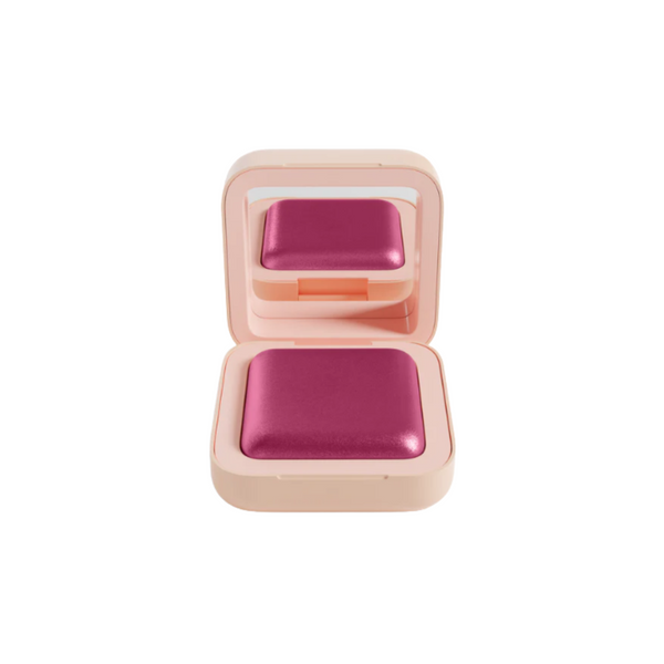 Pink compact powder in a open case on a white background